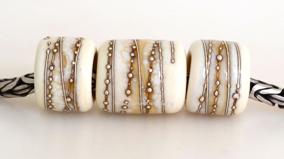 Ivory Silver Wraps Euro Charms Size: 10x12 & 15x12 mm Amount: 3 Beads Hole Size: 5 mm Three dark ivory glossy tube beads decorated with fine silver.  Default Title