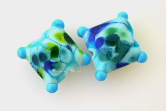 Nautical Fantasy Pair A pair of beads in a bright and dark green and blue frit blend on turquoise with dark turquoise corner dots. 13 mm price is per pair Glossy,Matte