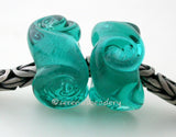 Twisted Teal Charm Pair A pair of transparent teal twisted glass beads that will fit your European charm style bracelet, although the bracelet is not for sale.~~~~~~~~~~~~~~~~~~~~~~~~~~7x15 mm2 Beads5 mm hole Glossy,Matte