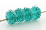 Teal Sugar Transparent teal lampwork glass beads with crystal clear sugar.Bead Size: 6x12 mmHole Size: 2.5 mmprice is for one bead with a discount for 4 or more Default Title