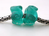 Twisted Teal Tumbled Charm Pair A pair of transparent teal twisted tumbled glass beads that will fit your European charm style bracelet, although the bracelet is not for sale.~~~~~~~~~~~~~~~~~~~~~~~~~~7x15 mm2 Beads5 mm hole Default Title