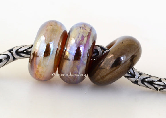Honor #2038 7x14 mm3 BeadsHole Size: 5 mm2 Sets available. Both sets show together in the last photo.~ Gold, pink gold, and bronze luster metallic donut-shaped beads. ~ This lampwork glass bead set is ready to ship. Default Title
