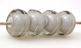 Gray White Heart With Fine Silver A gray white heart bead wrapped with strands of fine silver. 5x12 mm price is per bead Glossy,Matte
