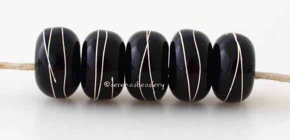 Black Silver Wraps #2019 6x11 mm5 BeadsHole Size: 2.5 mm~ All black fine silver wrapped beads. The fine silver is burnished to the glass bead while still hot in the flame. ~ This lampwork glass bead set is ready to ship. Default Title