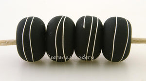 Black Matte Silver Wraps #2085 6x11 mm4 BeadsHole Size: 2.5 mm~ Black - in a matte finish - covered with fine silver wraps. ~ These lampwork glass beads are ready to ship. Default Title