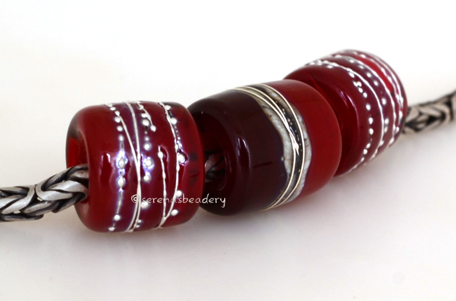 Red Hot Tube Beads Size: 11x13 & 15x13 mm Amount: 3 Beads Hole Size: 5  mm Two matching translucent red fine silver decorated tube beads and one red  two-toned bead with silvered