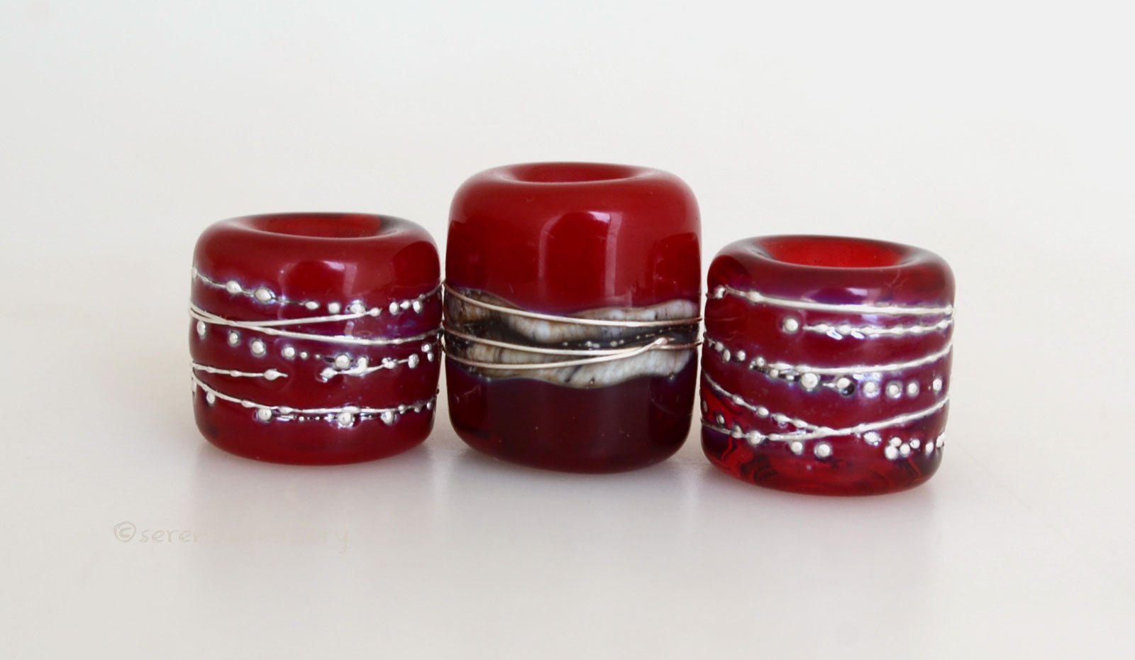 Red Hot Tube Beads Size: 11x13 & 15x13 mm Amount: 3 Beads Hole Size: 5  mm Two matching translucent red fine silver decorated tube beads and one red  two-toned bead with silvered