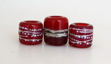 Red Hot Tube Beads Size: 11x13 &amp; 15x13 mm Amount: 3 Beads Hole Size: 5 mm Two matching translucent red fine silver decorated tube beads and one red two-toned bead with silvered ivory and more fine silver.  Default Title