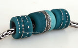 Star Struck - Mint and Teal Matte Size: 10x12 &amp; 14x12 mm Amount: 3 Beads Hole Size: 5 mm Two matching dark teal green tube beads decorated with fine silver and one mint and teal bead with silvered ivory and fine silver in a matte finish. Default Title