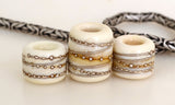 Ivory Silver Wraps Euro Charms Size: 10x12 &amp; 15x12 mm Amount: 3 Beads Hole Size: 5 mm Three dark ivory glossy tube beads decorated with fine silver.  Default Title