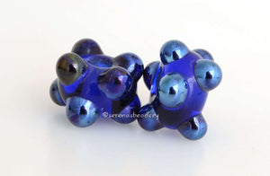 Deep Sapphire Luster Dots #2101 sapphire blue base beads dotted in silver blue metallic raised dots~~~~~~~~~~~~~~~~~~~~~~~~~~7x12 mm (bead size without dots)10 Beads2.5 mm hole These lampwork glass beads are ready to ship. Default Title