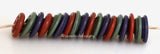 Wine Harvest Wavy Discs #2103 Purple, green and red spiral wavy disks3x14 mm18 BeadsHole Size: 2.5 mm These lampwork glass beads are ready to ship. Default Title