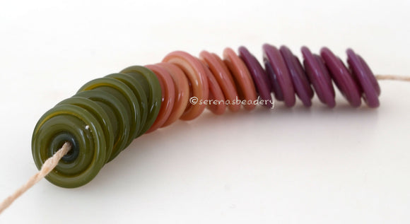 On the Spot Wavy Discs #2105 Green, peach, and purple spiral wavy disks3x14 mm18 BeadsHole Size: 2.5 mm These lampwork glass beads are ready to ship. Default Title