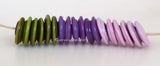 As We Go Wavy Discs #2106 Green, purple, and pink spiral wavy disks3x14 mm18 BeadsHole Size: 2.5 mm These lampwork glass beads are ready to ship. Default Title