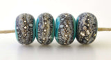 Copper Green Granite with Fine Silver Copper green, a light mint color, wrapped in silvered ivory and fine silver droplets. 5x11 mm 2.5 mm hole Price is per bead with discounts for larger quantities. Glossy,Matte
