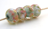 Lightly Romantic A light mint base, cased in clear and covered in cream and pink frit. Bead Size: 7x13 mm Hole Size: 2.5 mm price is for one bead with a discount for 4 or more Glossy,Matte