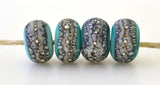 Copper Green Granite with Fine Silver Copper green, a light mint color, wrapped in silvered ivory and fine silver droplets. 5x11 mm 2.5 mm hole Price is per bead with discounts for larger quantities. Glossy,Matte