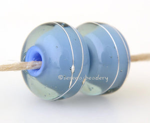 Light Blue Grey Thunder A layer of grey thunder over light blue with a silver wrap.   6x12 mm with a 2.5 mm hole. Price is per bead. Glossy,Matte