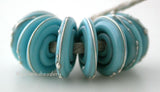 Light Turquoise Fine Silver Disc Opaque light turquoise wrapped in fine silver. 3x14mm Price is per bead. Glossy,Matte