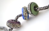 Home Range Granite Trio Charms The colors are light violet, cobalt blue, and olive green granite with silver droplets.~~~~~~~~~~~~~~~~~~~~~~~~~~6x14 mm3 Beads5 mm hole Glossy,Matte