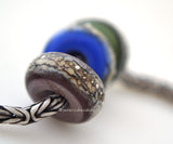 Home Range Granite Trio Charms The colors are light violet, cobalt blue, and olive green granite with silver droplets.~~~~~~~~~~~~~~~~~~~~~~~~~~6x14 mm3 Beads5 mm hole Glossy,Matte