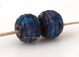 Purple Waltz Ribbed Pair #2090 A pair of round ribbed lampwork glass bead in dark purple with violet.~~~~~~~~~~~~~~~~~~~~~~~~~~9x12 mm2 Beads2.5 mm hole These lampwork glass beads are ready to ship. Default Title