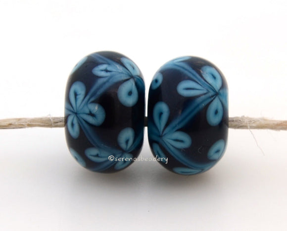 Sky Blue Purple Flowers #1724 Size: 6x12 mm, Amount: 2 Beads, Hole Size: 2.5 mm~ A sky blue and deep purple vine flower pair. Comes in a glossy finish. ~ These beads are ready to ship. Default Title