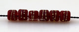 Tiny Tube Red Fine Silver Dots red tube-shaped lampwork glass beads decorated with fine silver dotsThe last picture shows these in my hand for size reference. They are tiny tiny tiny!!~~~~~~~~~~~~~~~~~~~~~~~~~~6x6 mm6 Beads1.5 mm hole Default Title