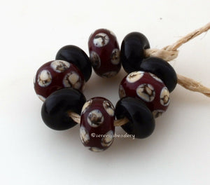 Red Silvered Ivory Dots #1832 Size: 5x10 and 6x11 mm ~ 9 beads ~ Hole Size: 2.5 mm~ 4 dark red beads with silvered ivory dots and 5 black spacers ~ These beads are ready to ship. Default Title