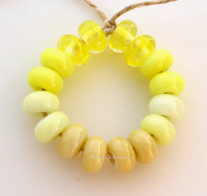 Happy Spacer Set #1907 6x10 mm16 BeadsHole Size: 2.5 mm~ Four spacer beads in 4 colors - yellow swirly to nougat cream. ~ This lampwork bead set is ready to ship. Default Title
