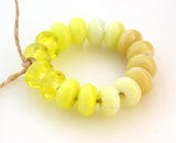 Happy Spacer Set #1907 6x10 mm16 BeadsHole Size: 2.5 mm~ Four spacer beads in 4 colors - yellow swirly to nougat cream. ~ This lampwork bead set is ready to ship. Default Title