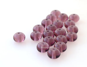 Light Amethyst Spacers #1918 7x11 mm20 BeadsHole Size: 1.5 mm~ Twenty light amethyst round spacers. ~ These lampwork beads are ready to ship. Default Title