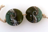 Dark Olive Silvered Ivory Lentil Pair #1890 15x15 mm2 BeadsHole Size: 1.5 mm~ two-toned olive lentils with silvered ivory and a twist. ~ These glass lampwork beads are ready to ship. Default Title