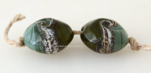 Dark Olive Silvered Ivory Lentil Pair #1890 15x15 mm2 BeadsHole Size: 1.5 mm~ two-toned olive lentils with silvered ivory and a twist. ~ These glass lampwork beads are ready to ship. Default Title