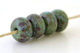 Green Fields Soft green lampwork glass beads with a dusting of pink, blue, and amethyst.Bead Size: 6x11-12 or 7x13-14 mmHole Size: 2.5 mmprice is for one bead with a discount for 4 or more 11-12 mm,Glossy,13-14 mm,Glossy,11-12 mm,Matte,13-14 mm,Matte