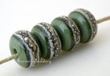 Olive Green Granite with Fine Silver Olive green wrapped in silvered ivory and fine silver droplets. 5x11 mm 2.5 mm hole Price is per bead with discounts for larger quantities. Glossy,Matte