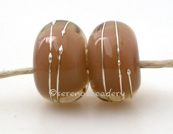 Pale Brown Chai Age Old A layer of pale brown over chai with a silver wrap.   6x12 mm with a 2.5 mm hole. Price is per bead. Glossy,Matte