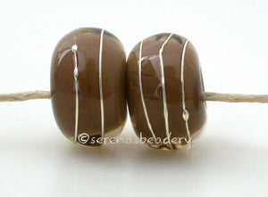Pale Brown Dark Brown Age Old A layer of pale brown over dark brown with a silver wrap.   6x12 mm with a 2.5 mm hole. Price is per bead. Glossy,Matte