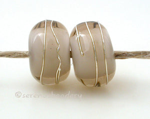 Pale Brown Age Old A layer of pale brown over white with a silver wrap.   6x12 mm with a 2.5 mm hole. Price is per bead. Glossy,Matte
