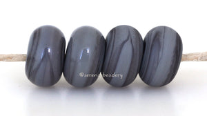 Porpoise Color Notes: An opaque gray with a hint of green. Available shapes and sizes:Round Bead Shapes: Available to order 8 to 15 mm with hole sizes ranging from 1.5 to 5 mm. See drop down menu for the exact options. Shown here in 8, 9 and 10 mm with both a 2.5 mm and 1.5 mm hole. 4 and 5 mm holes will fit European Charm style jewelry.Also available in a wavy disk or bead cap:. Pressed bead shapes:Lentil - 12x13 mm in size with a 1.5mm hole.: Pillow 13 mm square with a 1.5 mm hole.: Tab: Default Title