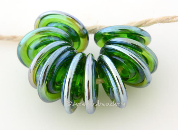 Iris Green Luster Wavy Disks 3x13-1410 BeadsHole Size: 2.5 mm~ A light green with a silver luster finish. Skinny little wavy disks. ~   Default Title