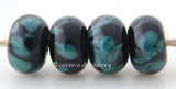 Black Ocean Black lampwork glass beads with tiny turquoise frit.Bead Size: 6x11-12 or 7x13-14 mmHole Size: 2.5 mmprice is for one bead with a discount for 4 or more 11-12 mm,Glossy,13-14 mm,Glossy,11-12 mm,Matte,13-14 mm,Matte