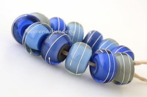 Blue Thunder Silver Wrap Set One pair each of 6 shades of blue and grey layers with a silver wrap. 12 beads total   6x12 mm with a 2.5 mm hole. Glossy,Matte