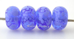 Spotted Blue Periwinkle Transparent blue beads covered in periwinkle blue colored frit. The picture shows them in both glossy and matte.Bead Size: 6x11-12 or 7x13-14 mmHole Size: 2.5 mmprice is for one bead with a discount for 4 or more 11-12 mm,Glossy,13-14 mm,Glossy,11-12 mm,Matte,13-14 mm,Matte