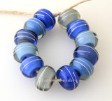Blue Thunder Silver Wrap Set One pair each of 6 shades of blue and grey layers with a silver wrap. 12 beads total   6x12 mm with a 2.5 mm hole. Glossy,Matte