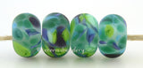 Jungle Gem Crystal clear lamwork glass beads with blue green and purple frit.Bead Size: 6x11-12 or 7x13-14 mmHole Size: 2.5 mmprice is for one bead with a discount for 4 or more 11-12 mm,Glossy,13-14 mm,Glossy,11-12 mm,Matte,13-14 mm,Matte
