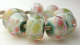 Lightly Romantic A light mint base, cased in clear and covered in cream and pink frit. Bead Size: 7x13 mm Hole Size: 2.5 mm price is for one bead with a discount for 4 or more Glossy,Matte
