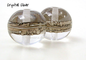 Saw Whet Silvered Ivory Rounds 2 different colors separated by silvered ivory and drizzled with fine silver in a super round shape.There are many color choices in the drop down menu to the right. Only choose custom if you want to order the new color combination we have been discussing.Approximately 10x12 mm or 13x15 mm Price is per bead. Crystal Clear,Glossy,12 mm,Crystal Clear,Glossy,15 mm,Crystal Clear,Matte,12 mm,Crystal Clear,Matte,15 mm,Amethyst/Sepia,Glossy,12 mm,Amethyst/Sepia,Glossy,15 mm,Amethyst/S