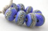 Dark Periwinkle Granite with Fine Silver Dark Periwinkle Blue wrapped in silvered ivory and fine silver droplets. 5x11 mm 2.5 mm hole Price is per bead with discounts for larger quantities. Glossy,Matte