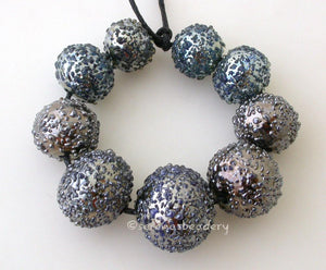 Disco Ball Graduated Set a graduated set of round disco balls lampwork glass beads   Bead Size: 10x10 to 15x15 mm Amount: 7 Beads Hole Size: 1.5 mm Default Title